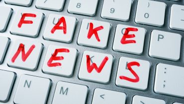 Words fake news written on a keyboard.