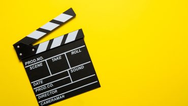 Movie clapper on a yellow background