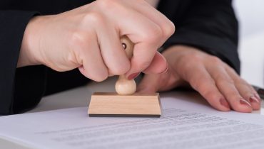 Businessperson Using Stamper On Document