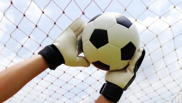goalkeeper's hands reaching for foot ball|classificacao algarve 21 jornada