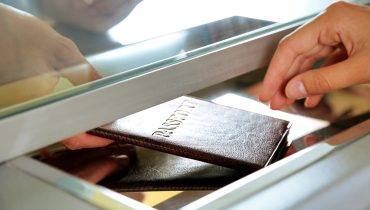 Woman buying tickets with passport at box office