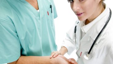 young nurse checking pulse of patient