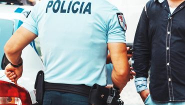 policeman detains a protester in the city