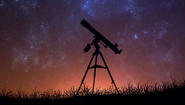 Infinite space background with silhouette of telescope. This image elements furnished by NASA.