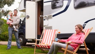 Family Enjoying Camping Holiday In Camper Van