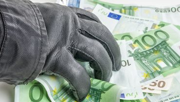 Thief with leather glove is grabbing some bills