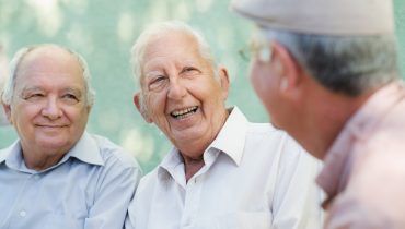 Group of happy elderly men laughing and talking