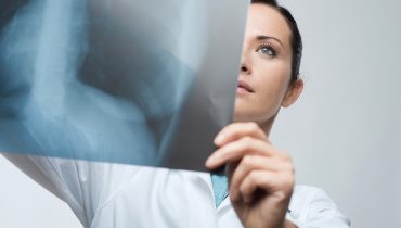 Female doctor examining x-ray image