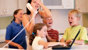 Frustrated mother with children on phone